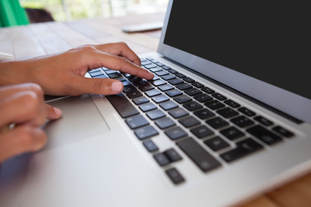 Hand of businesswoman using laptop on the table