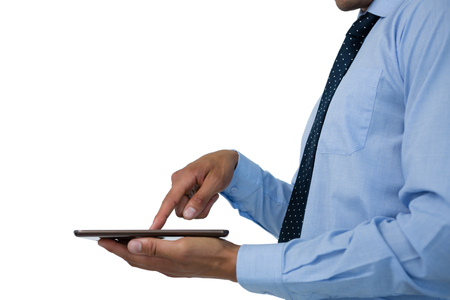 Mid section of  businessman using tablet against white backgroundの写真素材