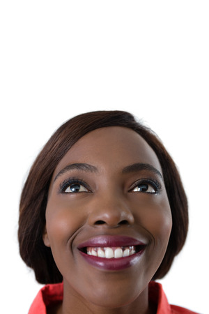 Close up of happy woman looking up against white backgroundの写真素材