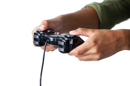 Hand of woman playing video game against white background