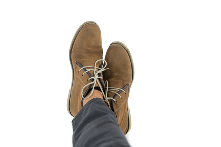 Low section of man wearing shoes against white backgroundの写真素材