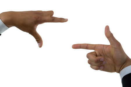 Cropped hands making finger frame against white backgroundの写真素材