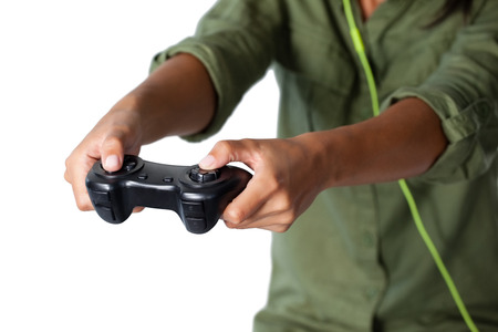 Mid section of woman playing video game against white backgroundの写真素材