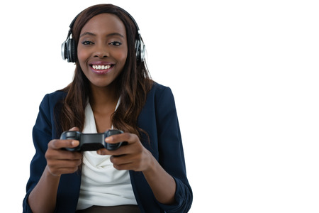 Cheerful businesswoman playing video game against white background