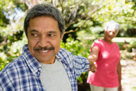 Happy senior couple enjoying in garden on a sunny dayの写真素材