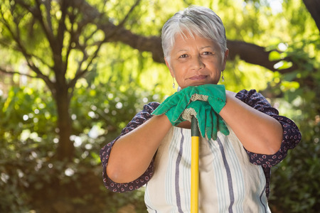 Portrait of senior woman standing in garden on a sunny day