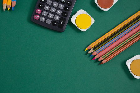 Close-up of various school supplies on green backgroundの写真素材
