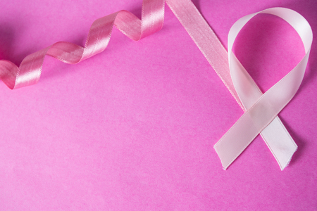 Overhead view of Breast Cancer ribbon against pink backgroundの写真素材