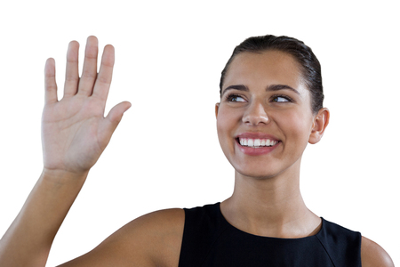 Close up of happy businesswoman touching invisible interface against white backgroundの写真素材