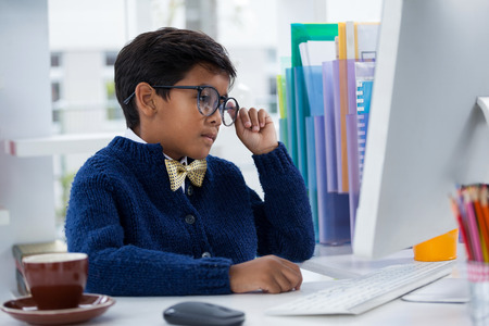 Businessman working while sitting at desk in office