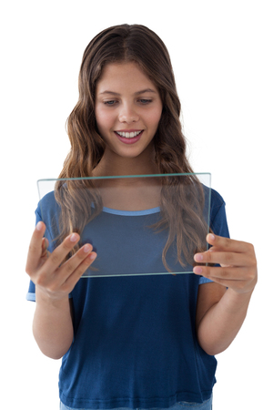 Girl using a glass digital tablet against white backgroundの写真素材