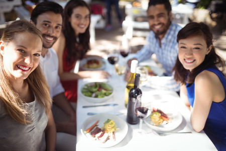 Group of friends clicking a selfie in a restaurantの写真素材