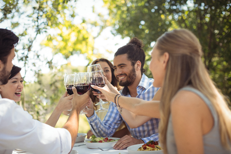 Group of friends toasting champagne glasses in a restaurant