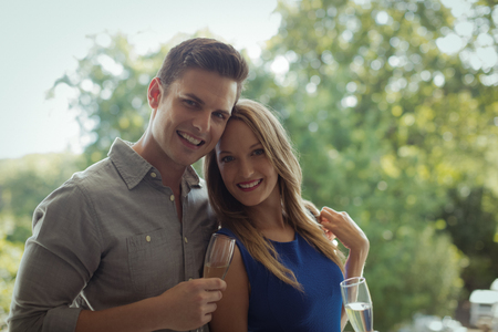 Portrait of couple having champagne in restaurantの写真素材