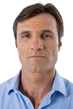 Portrait of businessman smiling against white backgroundの写真素材