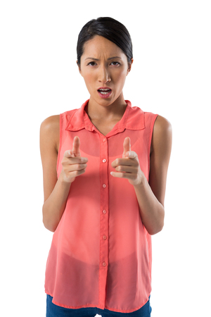 Portrait of woman gesturing against white backgroundの写真素材