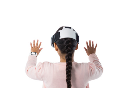 Rear view of girl pretending to touch an invisible screen against white background