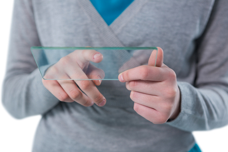 Mid section of teenage girl using a glass digital tabletの写真素材