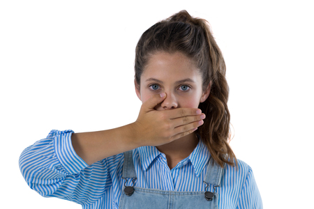 Portrait of surprised teenage girl standing against white backgroundの写真素材