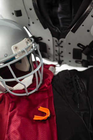 High angle view of chest protector with sports uniform by helmetの写真素材