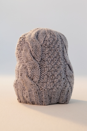 Close-up of wooly hat against white background