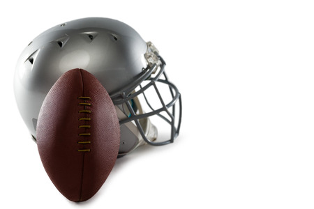 Close-up of helmet and American football on white backgroundの写真素材