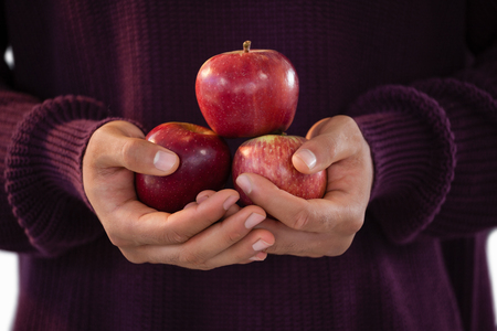 Close-up of man holding applesの写真素材