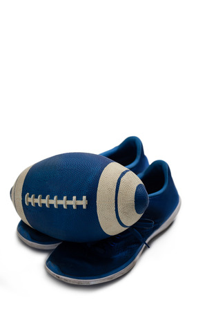 Close-up of American football and shoes on white backgroundの写真素材