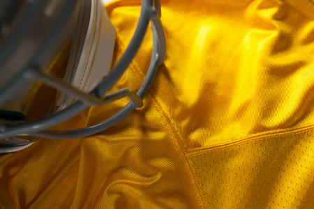 High angle view of sports helmet on yellow jerseyの写真素材