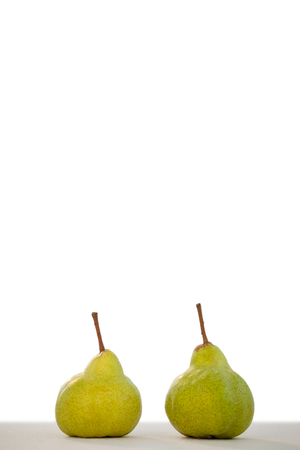 Close-up of two pears on table against white backgroundの写真素材