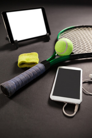 High angle view of technologies and tennis equipment on black backgroundの写真素材