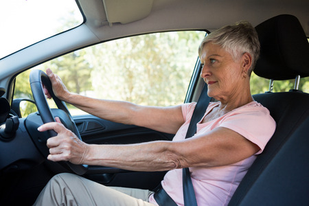 Active senior woman driving a car