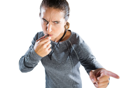 High angle view of female coach gesturing while whistling against white backgroundの写真素材