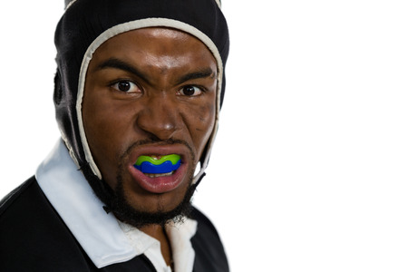 Portrait of male rugby player with mouthguard against white bakgroundの写真素材