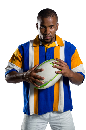 Confident male rugby player standing against white backgroundの写真素材