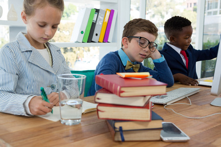 Kids as business executives working together in officeの写真素材