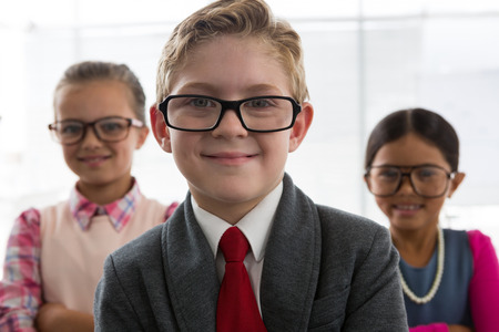 Portrait of kids as business executive smiling while standing in the office