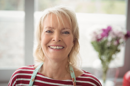 Close-up of smiling senior woman looking at camera