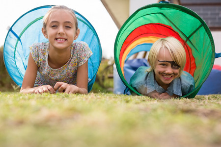 Portrait of children in tent tunnel during birthday partyの写真素材