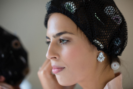 Bride getting ready for wedding at homeの写真素材