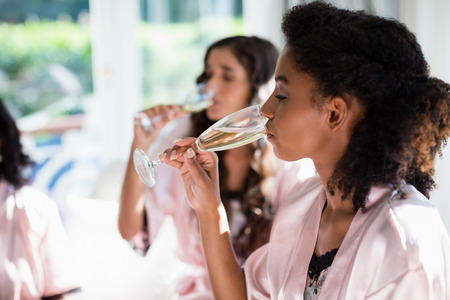 Women drinking a glasses of champagne at homeの写真素材