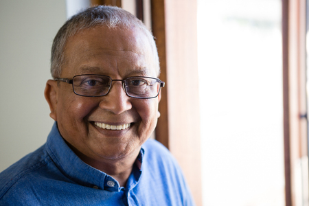 Close up portrait of happy senior man at nursing homeの写真素材