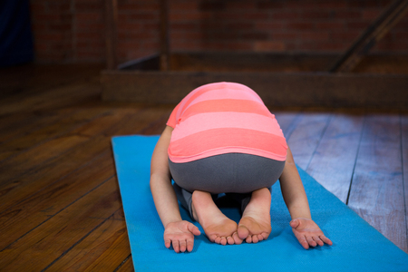 Teenage girl practicing yoga in fitness studioの写真素材