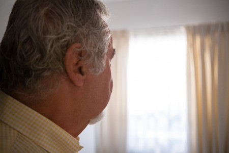 Close up of thoughtful senior man relaxing in nursing home