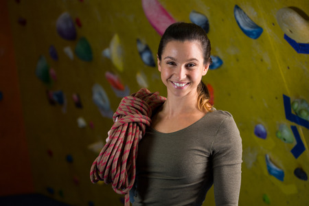 Portrait of happy woman with rope in fitness studioの写真素材