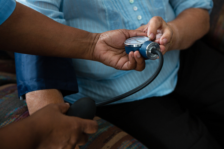 Cropped hands of nurse examining patient in nursing homeの写真素材