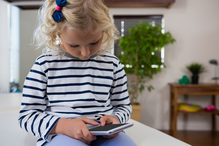 Girl using mobile phone in clinicの写真素材