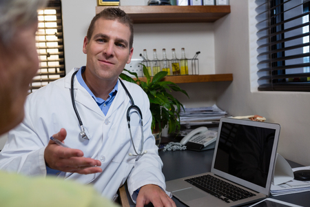 Physiotherapist explaining diagnosis to female patient in the clinicの写真素材
