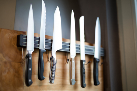 Close-up of kitchen knives hanging on the wallの写真素材