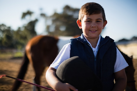 Boy smiling at camera in the ranch on a sunny dayの写真素材